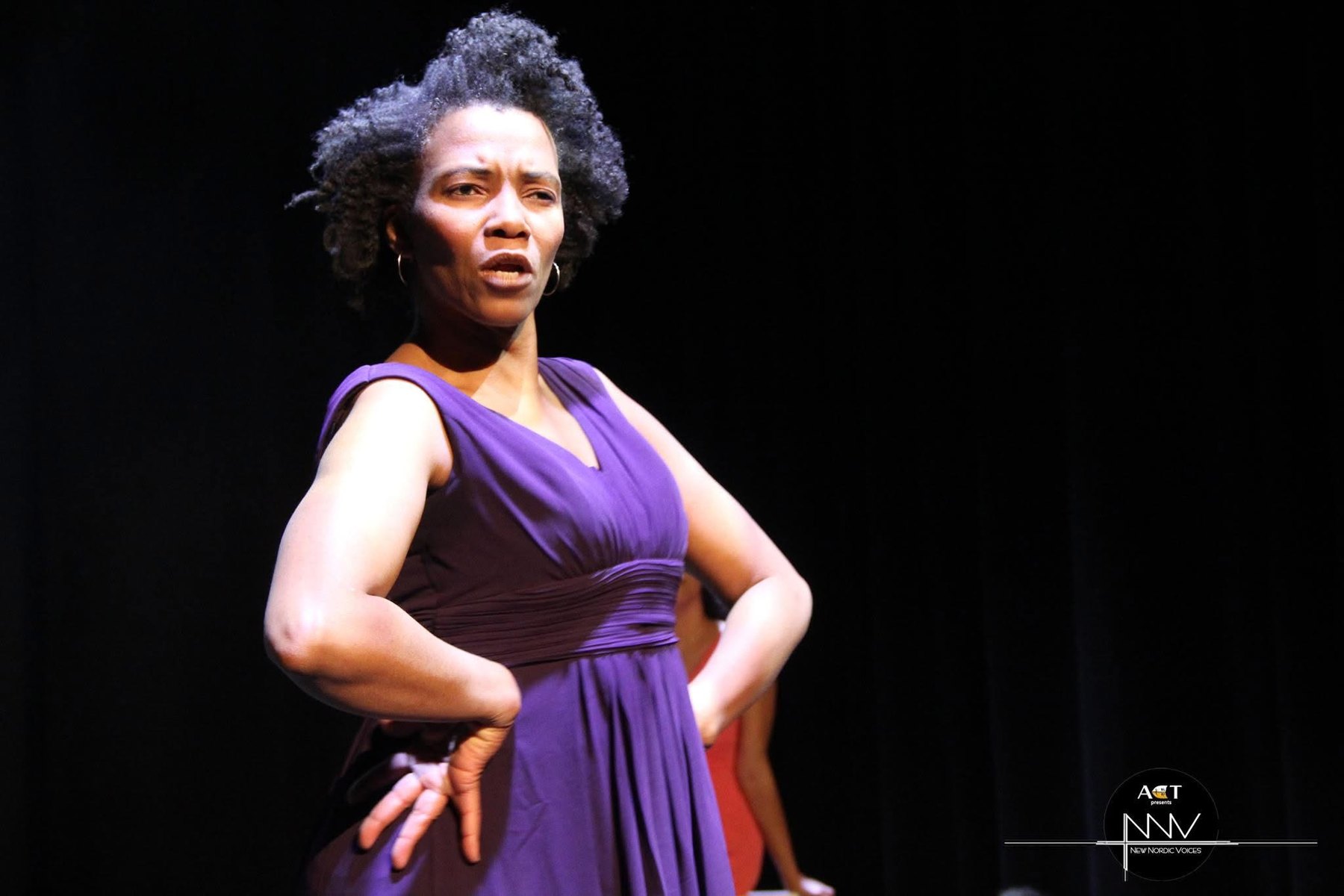 Portrait of a performer in purple dress.