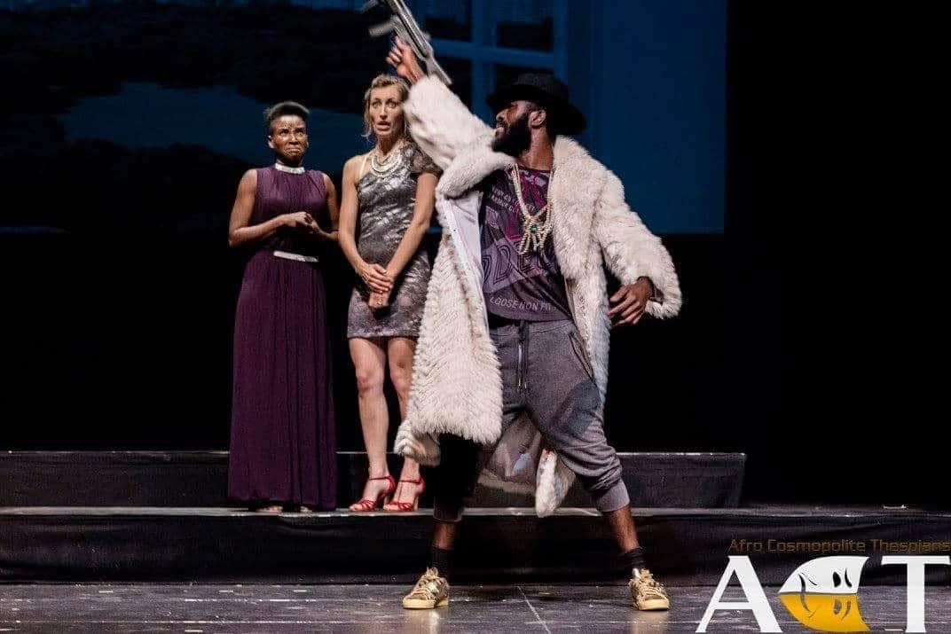 Prince of Morocco performing with theatrical swagger on stage in The Merchant of Venice.