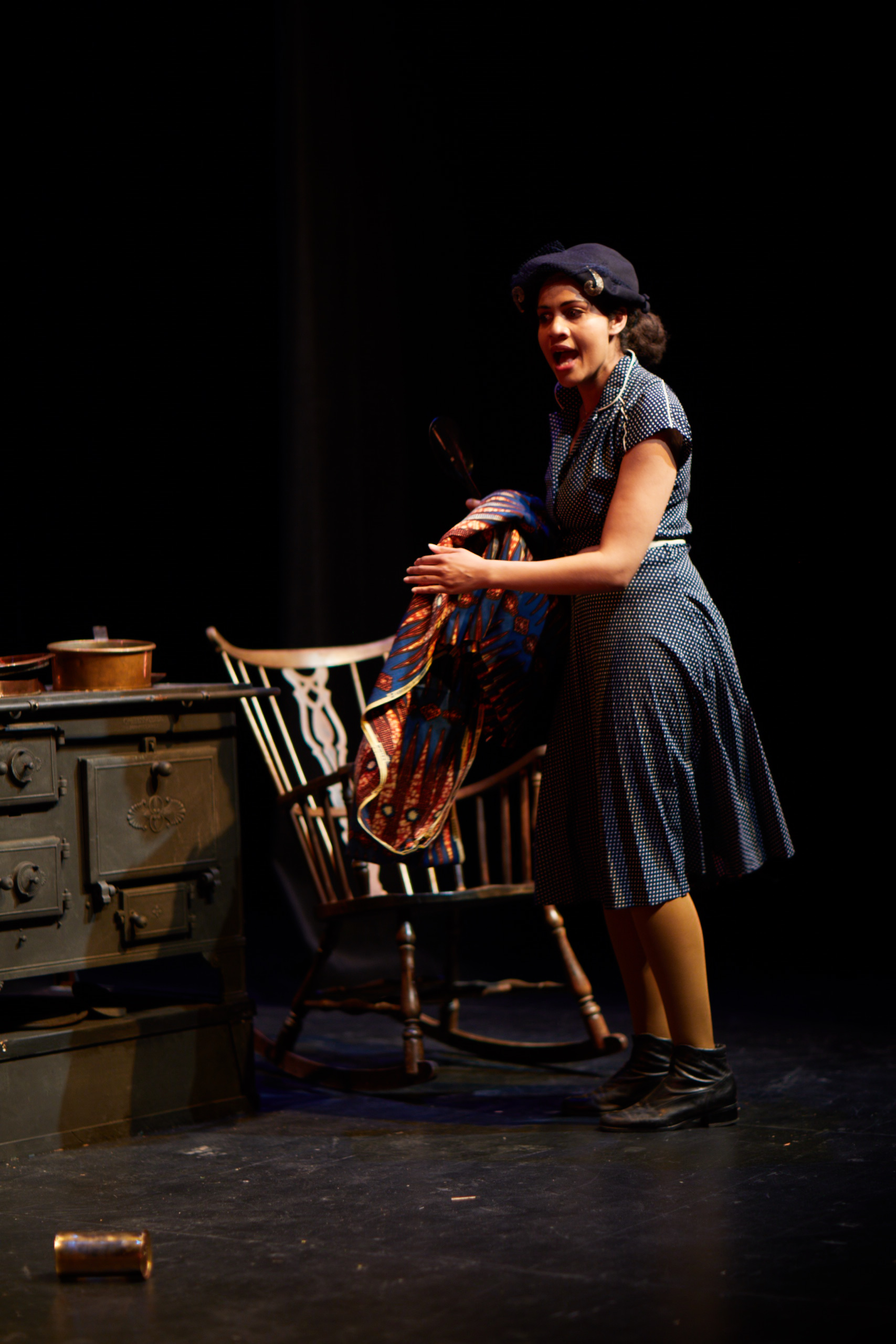 Christine tending the kitchen world of the play.